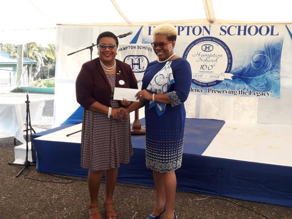Picture shhowing a check being presented to Hampton school